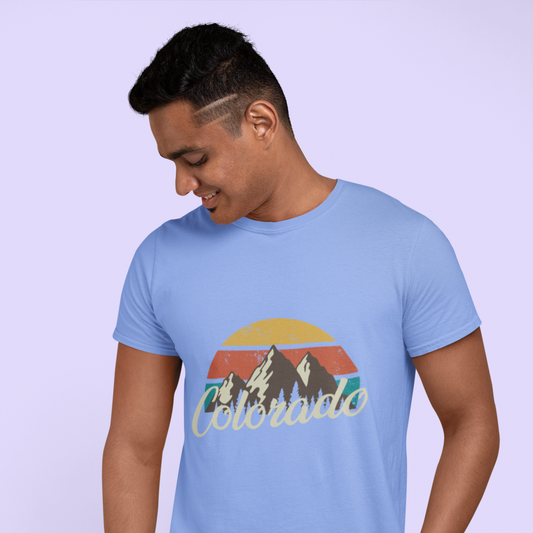 Person wearing a light blue t-shirt with a mountain graphic and 'Colorado' text on a light purple background
