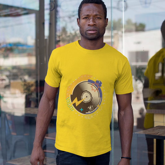 Man wearing a yellow t-shirt with a graphic design in an outdoor setting