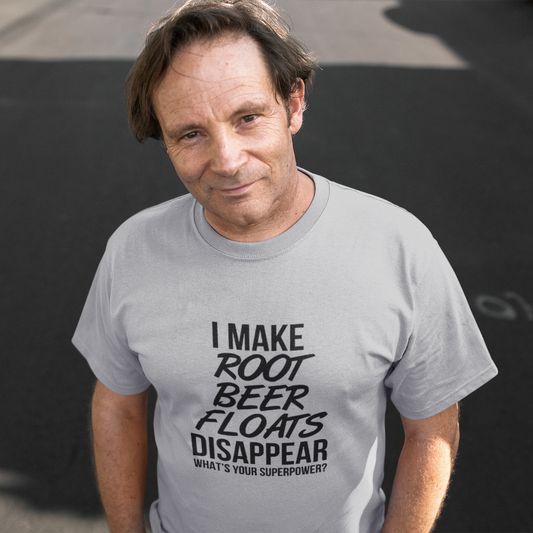 Man wearing a gray t-shirt with a humorous text design on a dark background