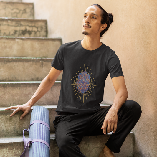 Man sitting on steps with a yoga mat, wearing a black t-shirt with a graphic design.