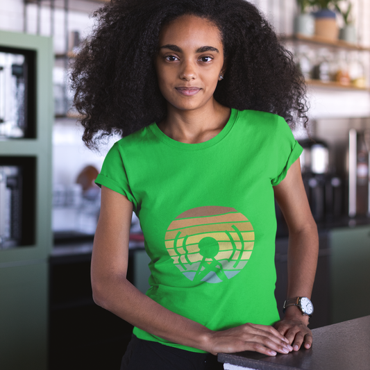 Person wearing a green t-shirt with a colorful logo in an indoor setting