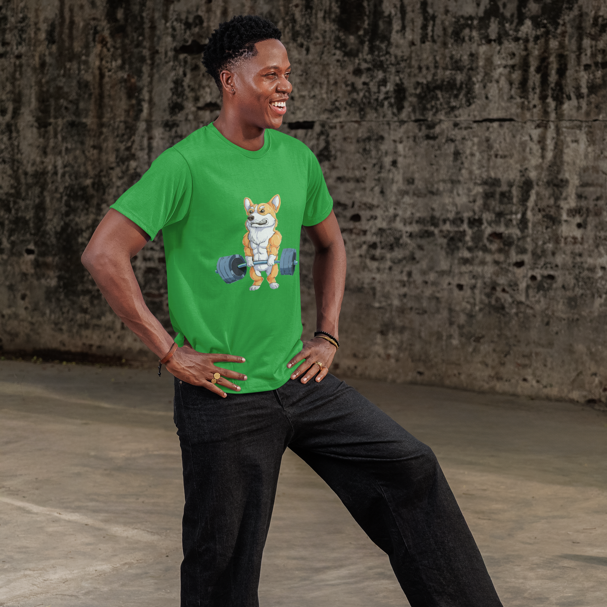 Man wearing a green t-shirt with a graphic design, standing against a textured wall.