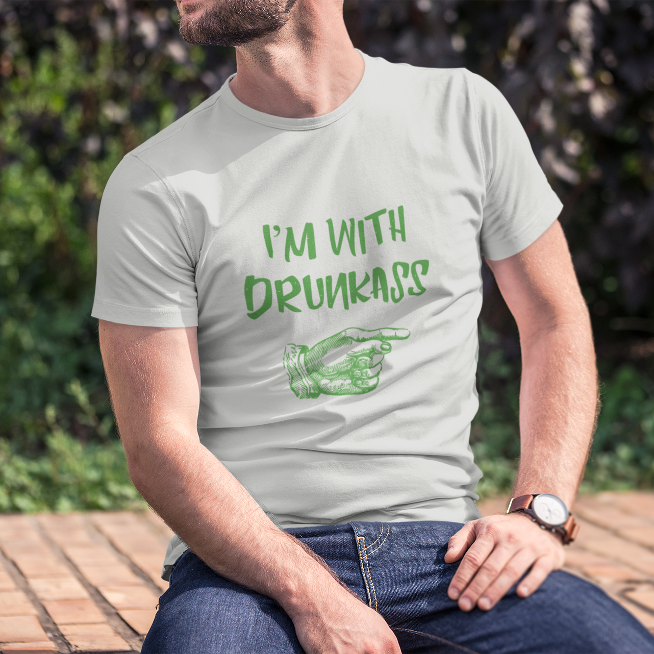 Person wearing a t-shirt with 'I'm with drunkass' text sitting outdoors.
