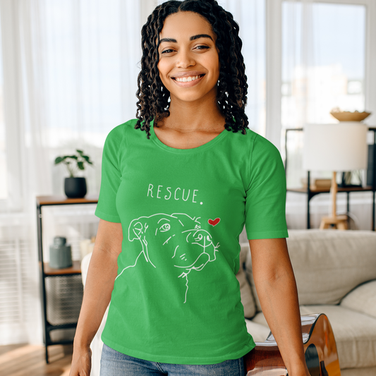 Woman wearing a green t-shirt with 'Rescue' and a dog illustration, holding a guitar in a living room.