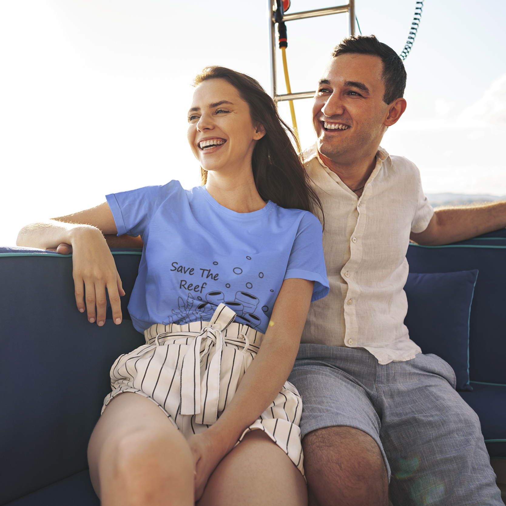 Man and woman sitting on a boat, smiling and enjoying each other's company.
