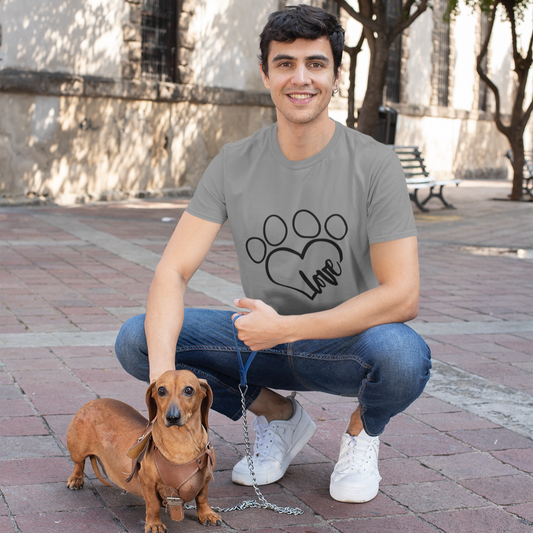 Man squatting with a small dog on a leash in an outdoor setting