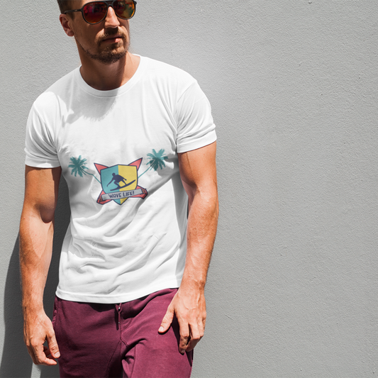 Man wearing a white t-shirt with a colorful graphic design against a gray wall.