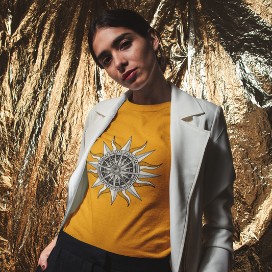 Person wearing a yellow t-shirt with a sun design against a gold leaf background