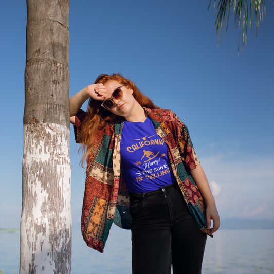 Person standing by a palm tree with a blue sky and ocean background