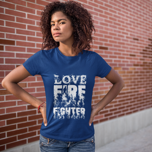 Woman wearing a blue t-shirt with 'LOVE FIRE FIGHTER' text against a brick wall.
